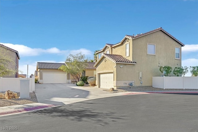 view of front of property with a tile roof, fence, and stucco siding