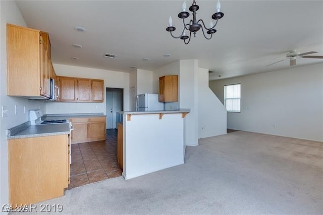 kitchen featuring electric stove, light colored carpet, freestanding refrigerator, open floor plan, and ceiling fan with notable chandelier