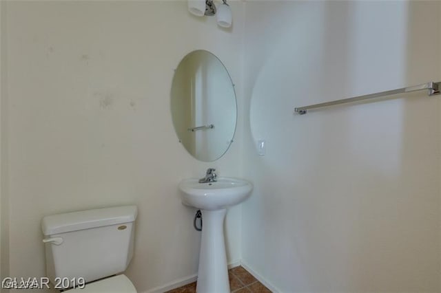 half bath featuring a sink and toilet