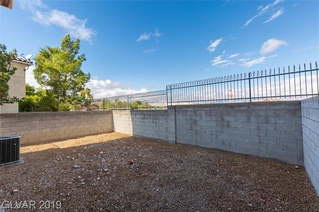 view of yard with cooling unit and a fenced backyard