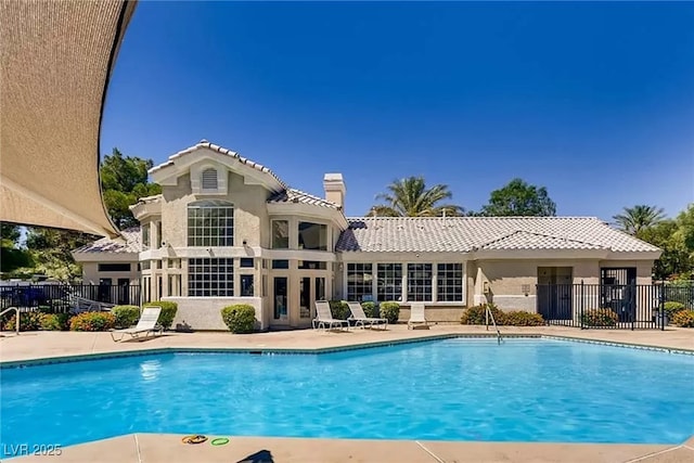 pool featuring fence and a patio