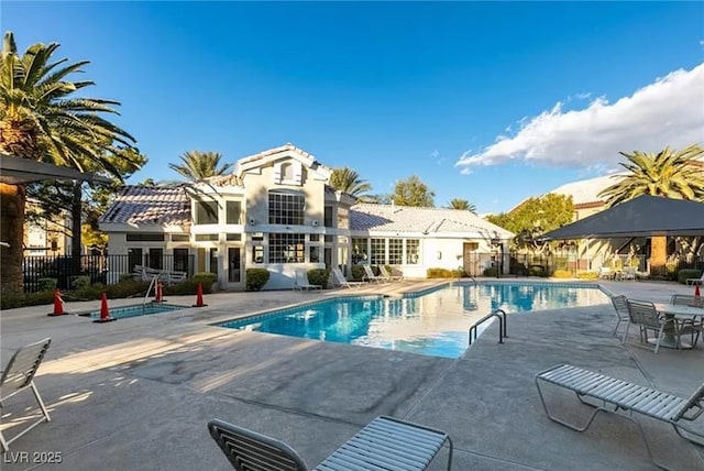 pool featuring fence and a patio