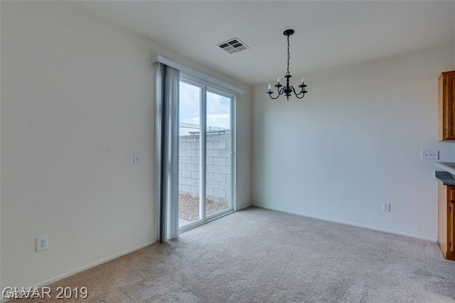 interior space with carpet, visible vents, and a notable chandelier