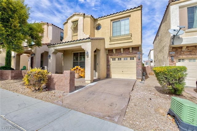 mediterranean / spanish-style house featuring driveway, a tiled roof, a garage, and stucco siding