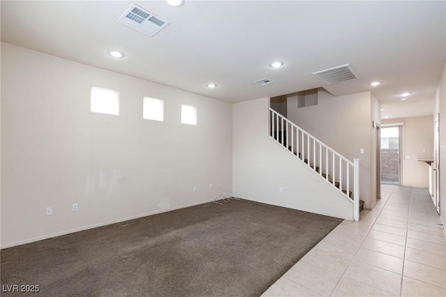 interior space featuring stairs, visible vents, and light colored carpet