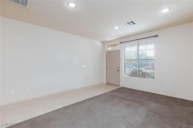 tiled empty room with carpet, visible vents, and recessed lighting