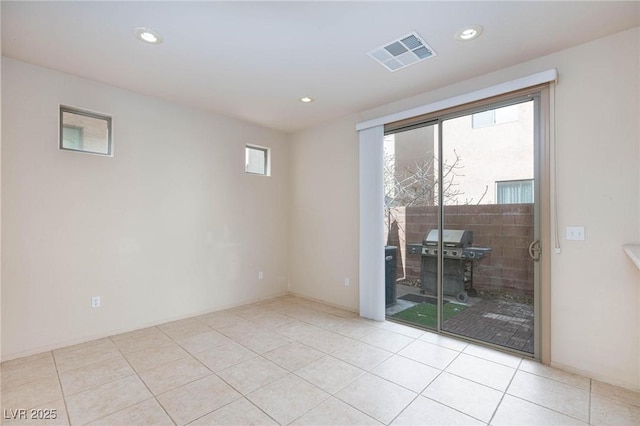 unfurnished room with plenty of natural light, visible vents, and recessed lighting