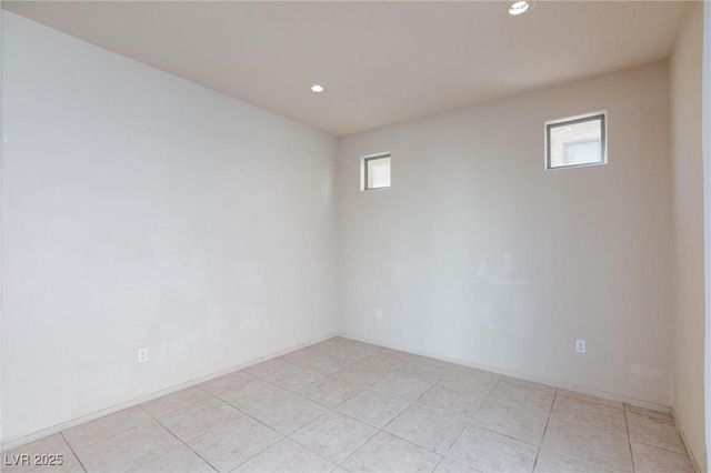 spare room with light tile patterned floors, plenty of natural light, and recessed lighting