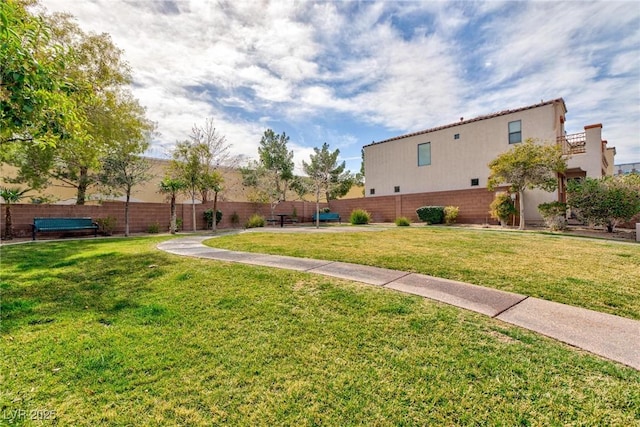 surrounding community featuring a yard and fence