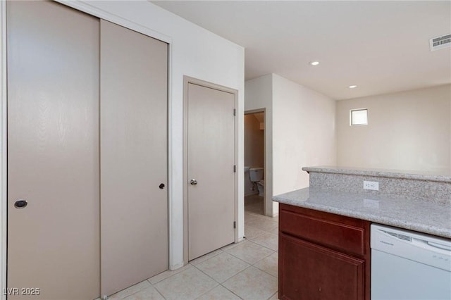 kitchen with light stone counters, recessed lighting, visible vents, light tile patterned flooring, and white dishwasher