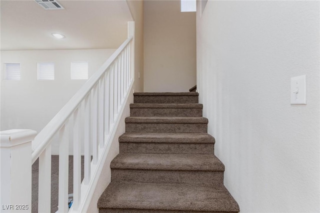 stairway with visible vents and recessed lighting