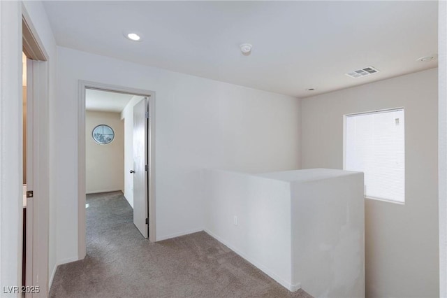 hall featuring recessed lighting, carpet flooring, visible vents, and baseboards