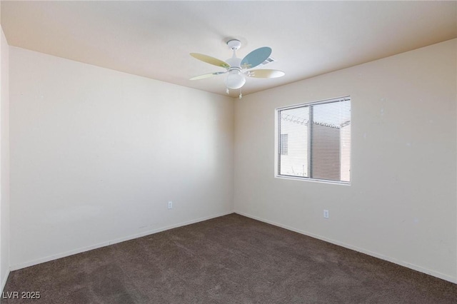 spare room with a ceiling fan, carpet, and baseboards