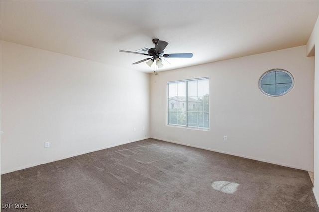 empty room with carpet flooring and a ceiling fan