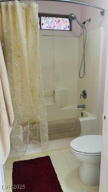 bathroom with tile patterned flooring, shower / tub combo with curtain, and toilet