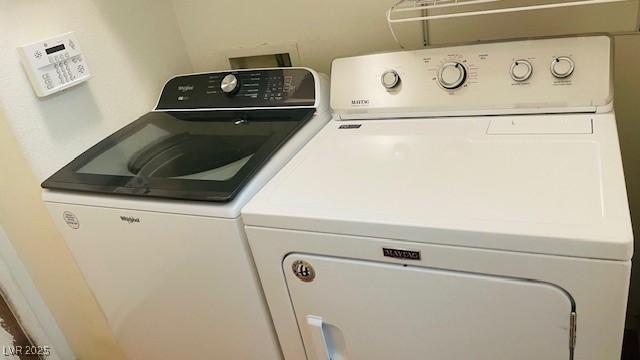 clothes washing area featuring laundry area and separate washer and dryer