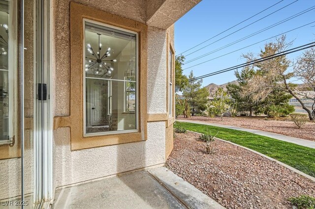 doorway to property featuring stucco siding