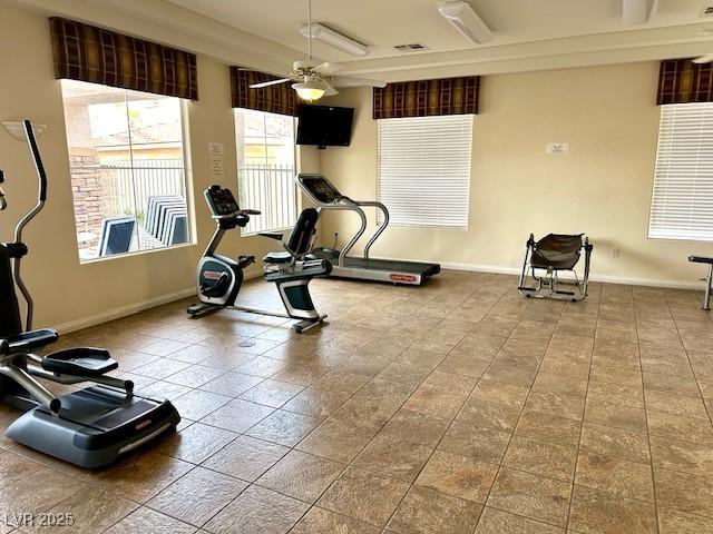 workout area with tile patterned flooring, visible vents, baseboards, and a ceiling fan