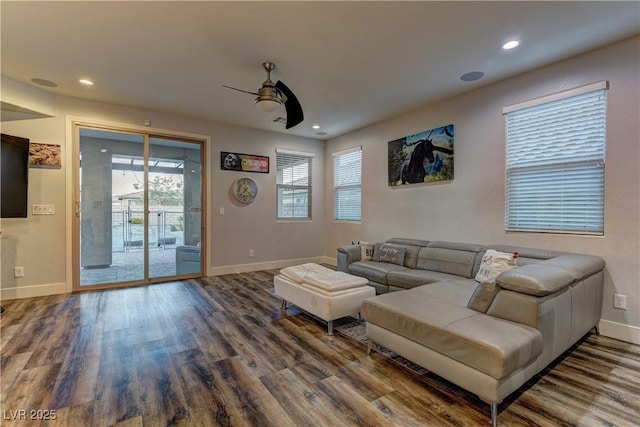 living area with recessed lighting, wood finished floors, a ceiling fan, and baseboards