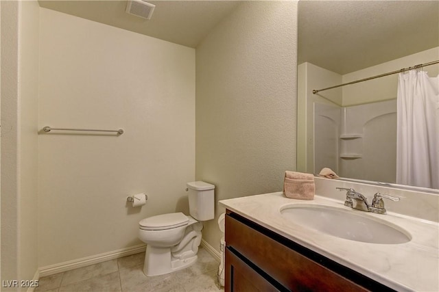 bathroom featuring visible vents, toilet, vanity, baseboards, and tile patterned floors