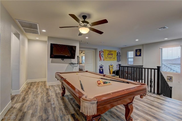 game room with a healthy amount of sunlight, visible vents, and wood finished floors