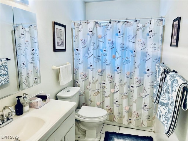 bathroom featuring toilet, tile patterned floors, and vanity