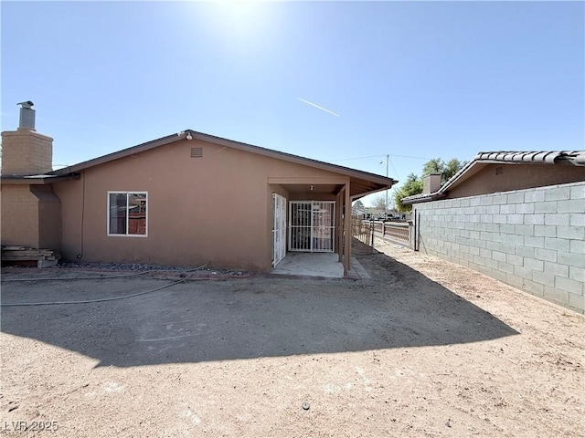 exterior space featuring fence and stucco siding