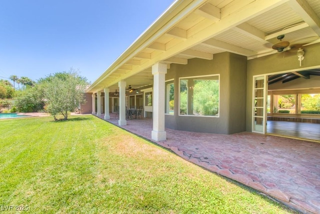 exterior space with ceiling fan