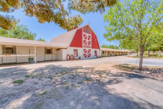 view of property with a barn