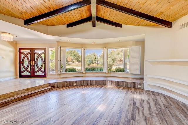 interior space with lofted ceiling with beams, wood finished floors, wood ceiling, visible vents, and french doors