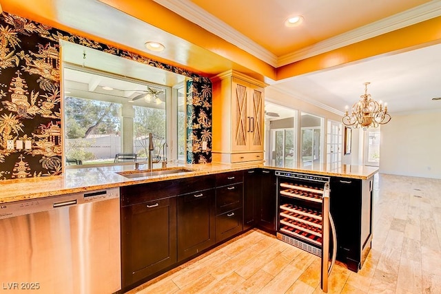 bar featuring a sink, light wood-style flooring, ornamental molding, and dishwasher