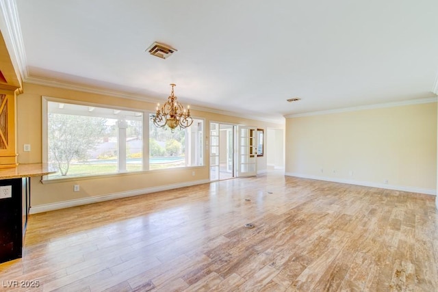 unfurnished living room with baseboards, light wood-style flooring, ornamental molding, and a notable chandelier