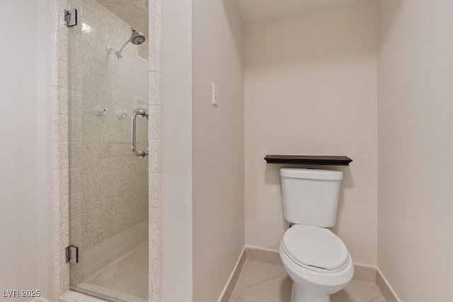 bathroom featuring baseboards, a shower stall, toilet, and tile patterned floors