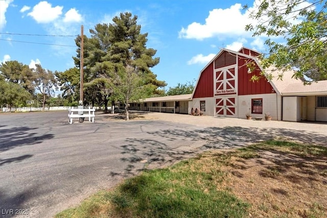 view of property featuring a barn