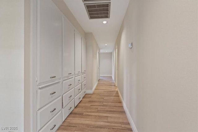 hallway featuring recessed lighting, visible vents, light wood-style flooring, and baseboards