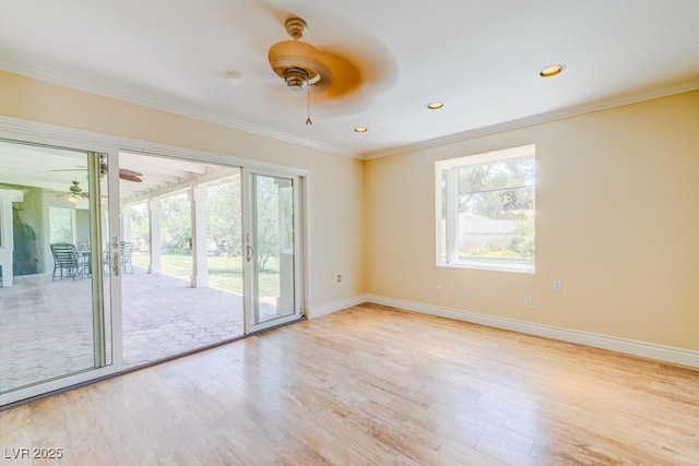 unfurnished room featuring baseboards, light wood-style flooring, ornamental molding, and a wealth of natural light