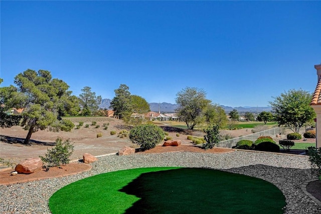 view of yard with fence and a mountain view