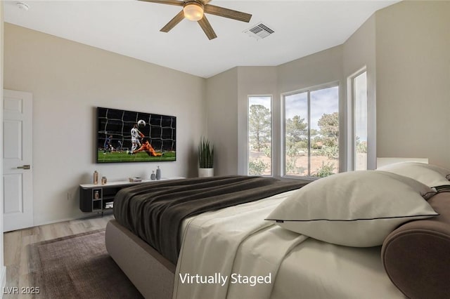 bedroom featuring visible vents, ceiling fan, and wood finished floors