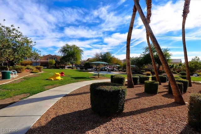 view of home's community with a yard