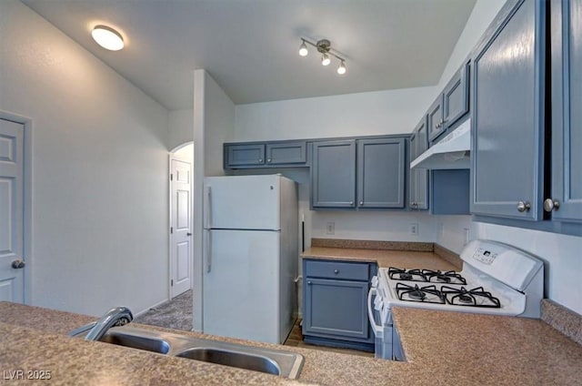 kitchen featuring light countertops, white appliances, a sink, and under cabinet range hood