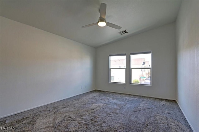 unfurnished room with visible vents, a ceiling fan, carpet flooring, vaulted ceiling, and baseboards