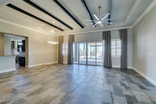 empty room with beamed ceiling, plenty of natural light, and baseboards