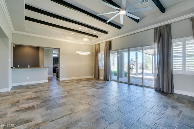 empty room featuring visible vents, a ceiling fan, beam ceiling, and baseboards