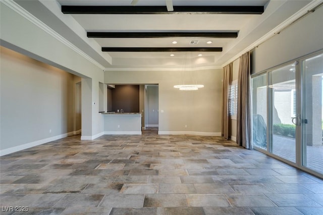 spare room with beam ceiling and baseboards