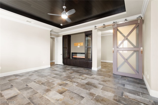 unfurnished room featuring a tray ceiling, wooden ceiling, a barn door, baseboards, and ceiling fan