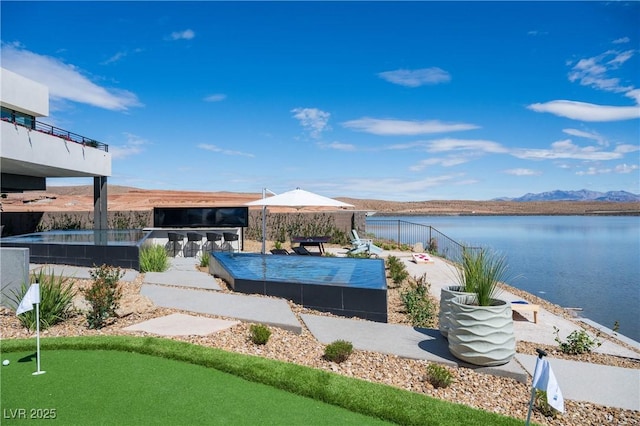 exterior space with a water and mountain view