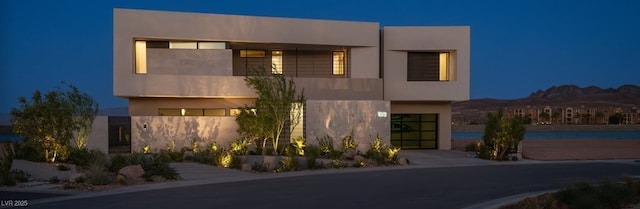 modern home featuring a balcony and stucco siding