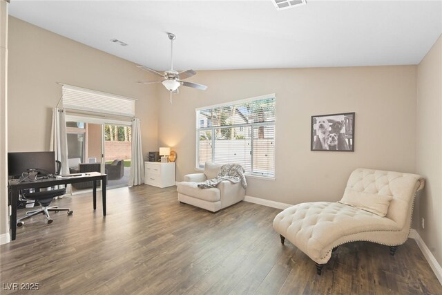 office space with vaulted ceiling, visible vents, baseboards, and wood finished floors