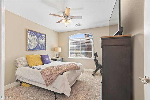 carpeted bedroom with visible vents, ceiling fan, and baseboards