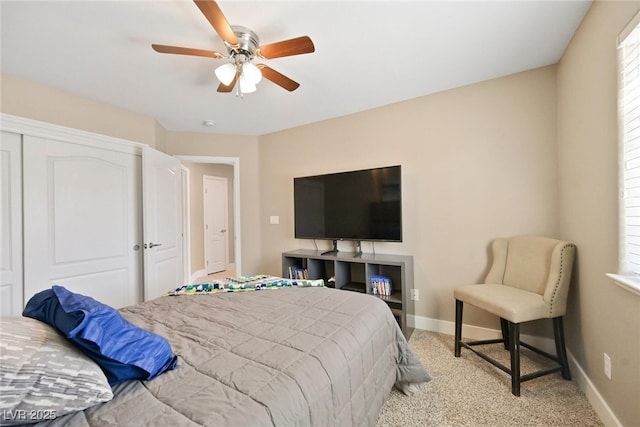 bedroom featuring carpet flooring, multiple windows, a ceiling fan, and baseboards